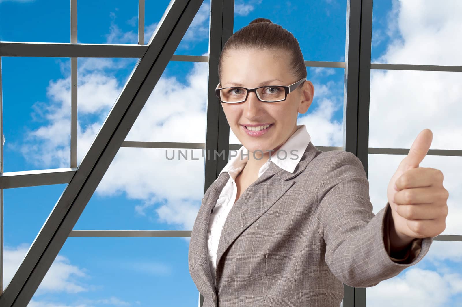 Portrait of a young cute woman with thumb up