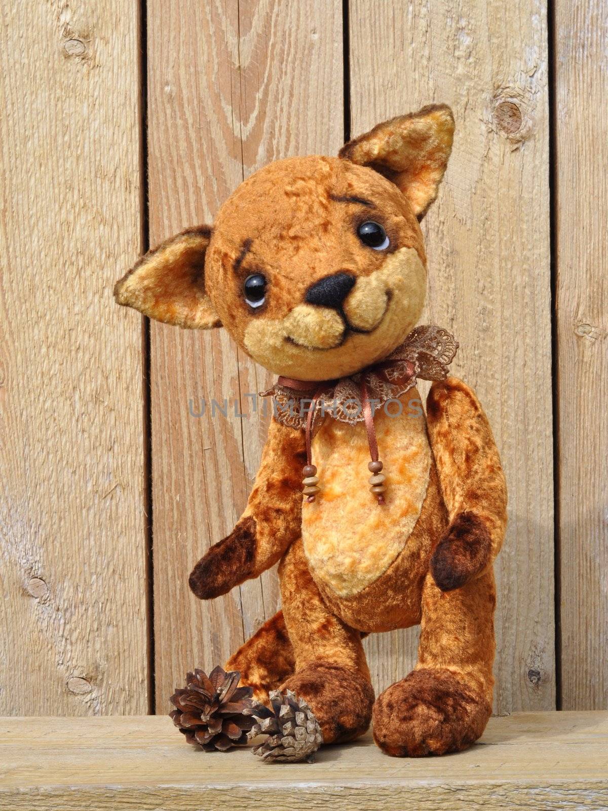 Handmade, the sewed plush toy: Ron fox cub on a board among flowers