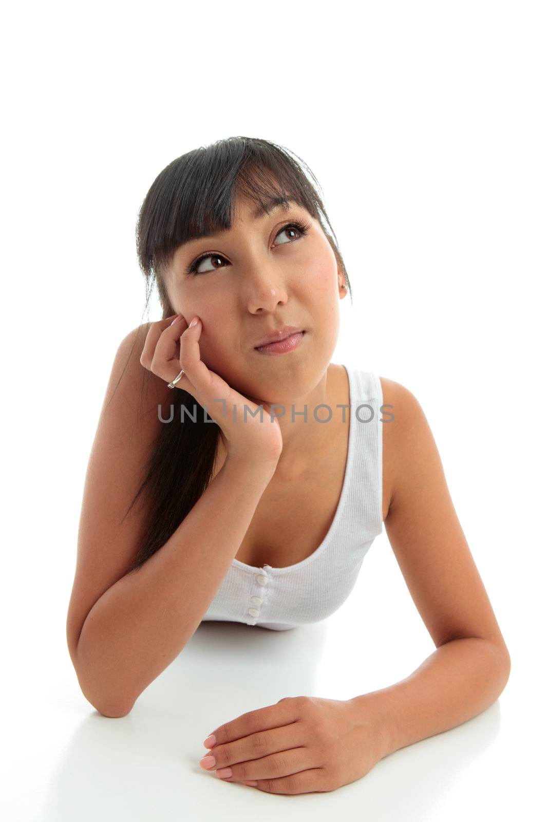 A young woman pondering or thinking.  She is looking up.  Space for copy.  White background.