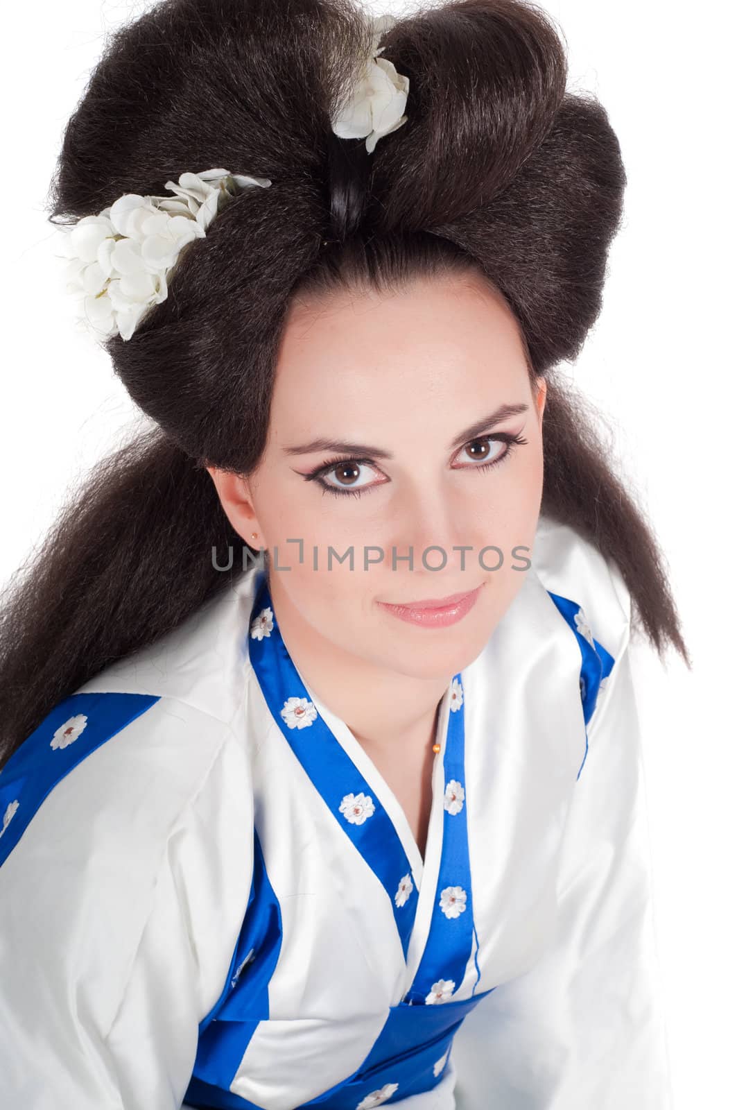 Portrait of the girl of the Asian appearance with a make-up under the geisha on a white background