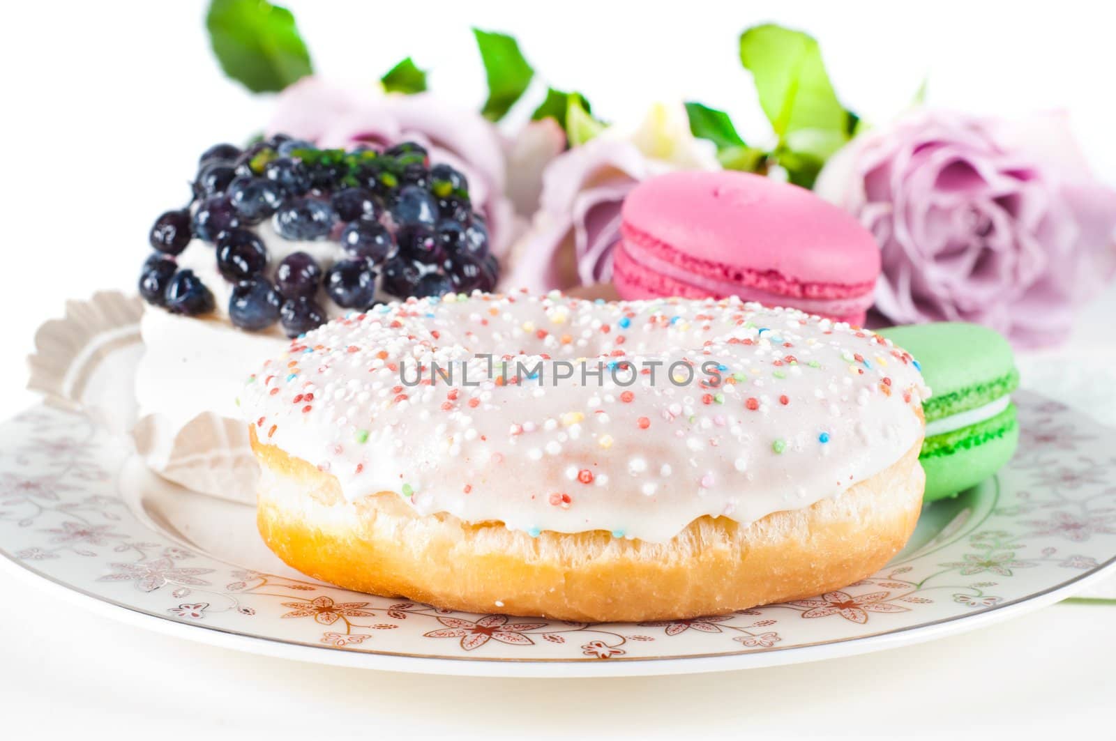 Sweets and roses in studio isolated on white