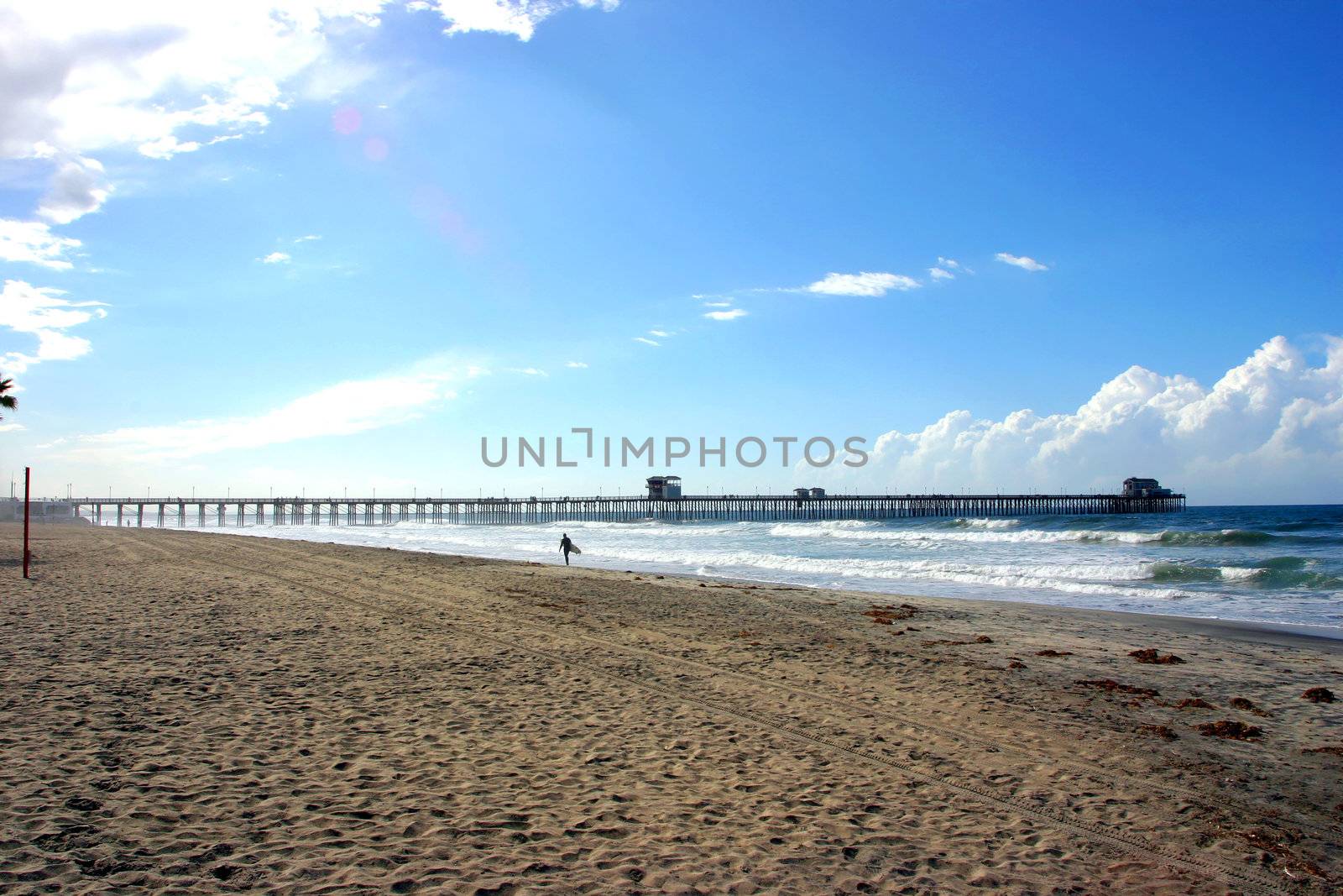 Sole Surfer walking on the Beach in Oceanside by KevinPanizza