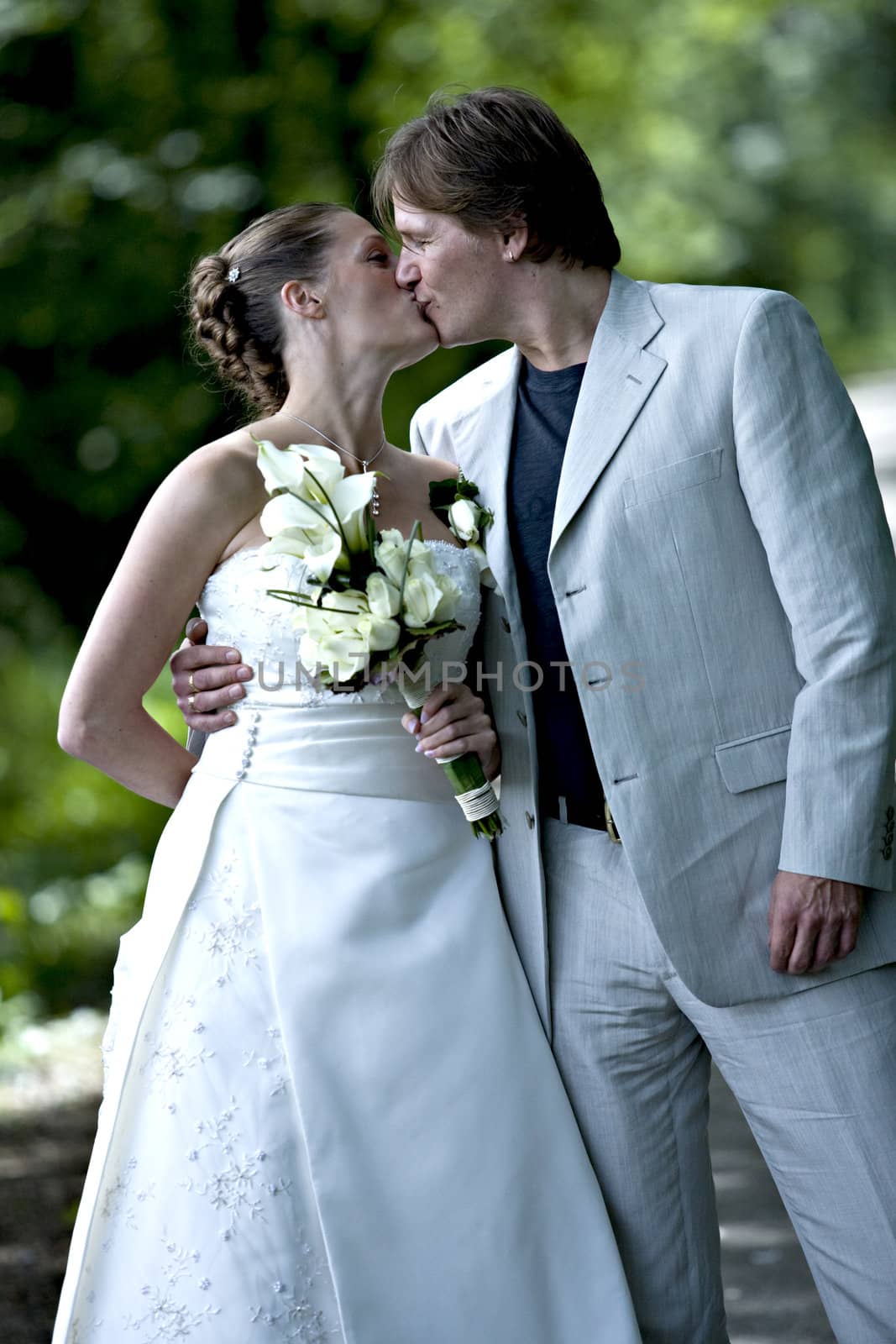 Wedding couple posing with a kiss