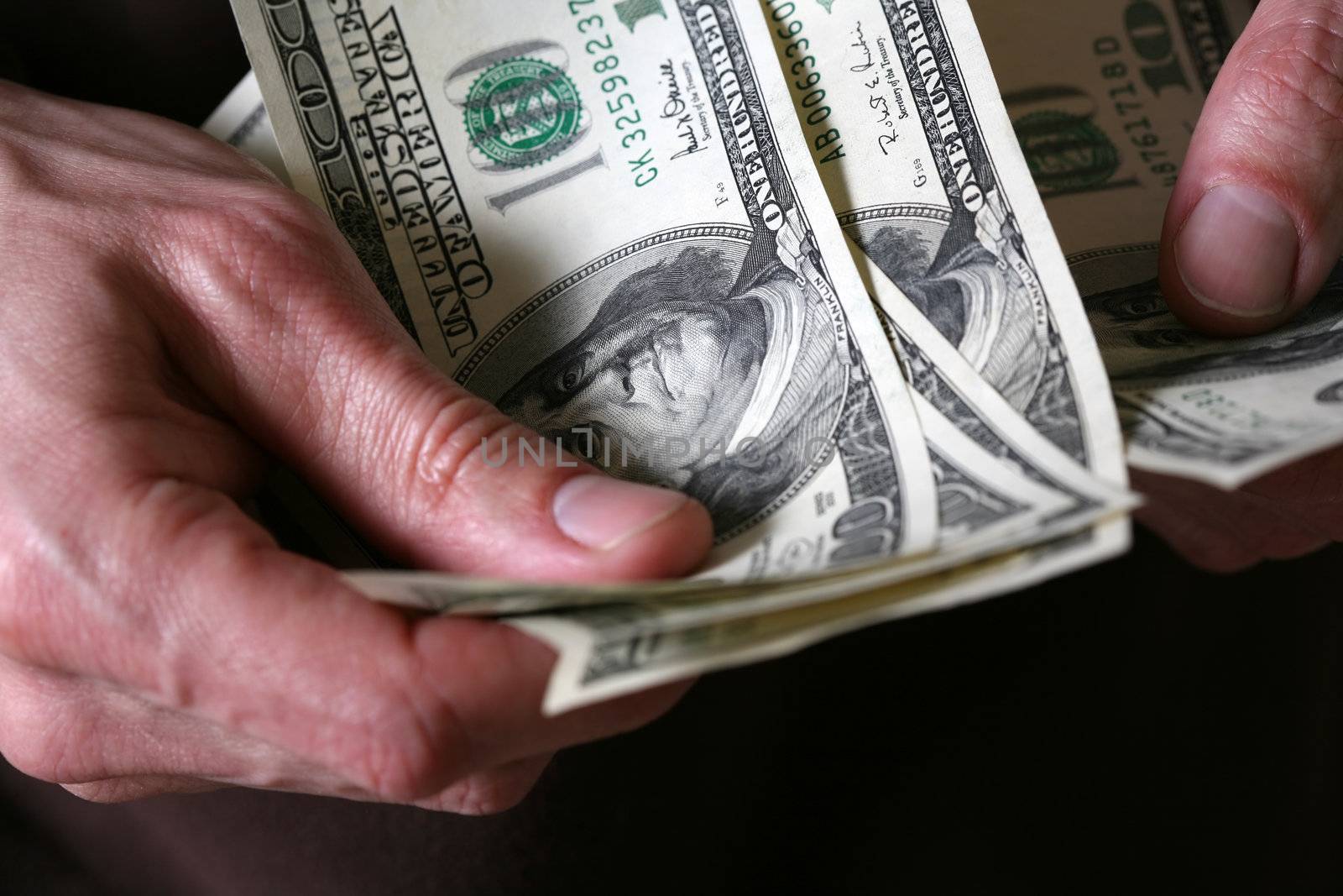Man's hands hold dollars banknotes money