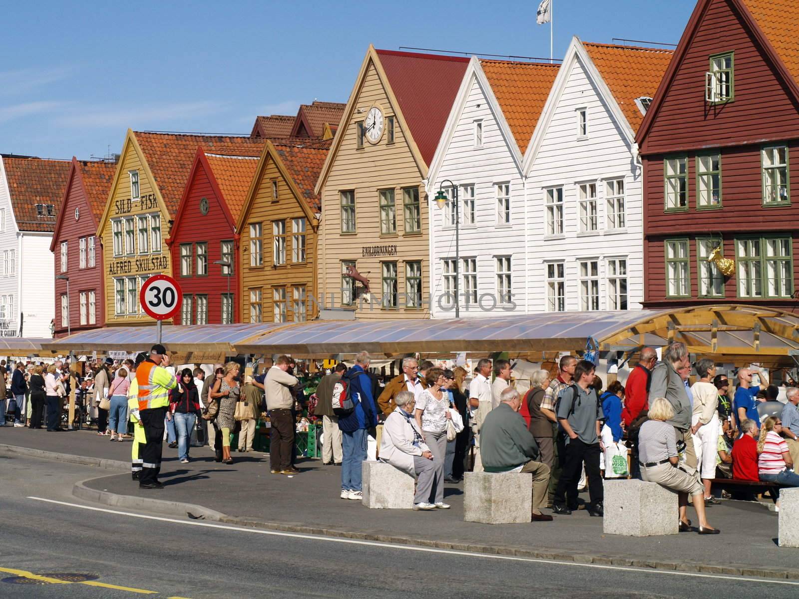 people on bryggen in Bergen Norway by viviolsen