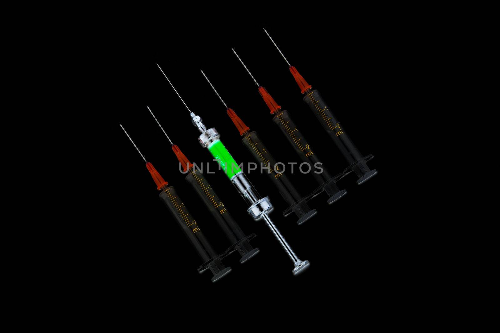 six various syringes in row on black background by zhu_zhu
