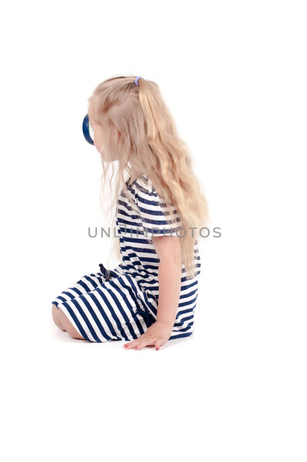 Shot of little cute girl with loupe in studio