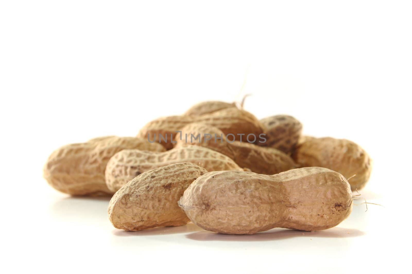 Peanuts in a pile on a white background