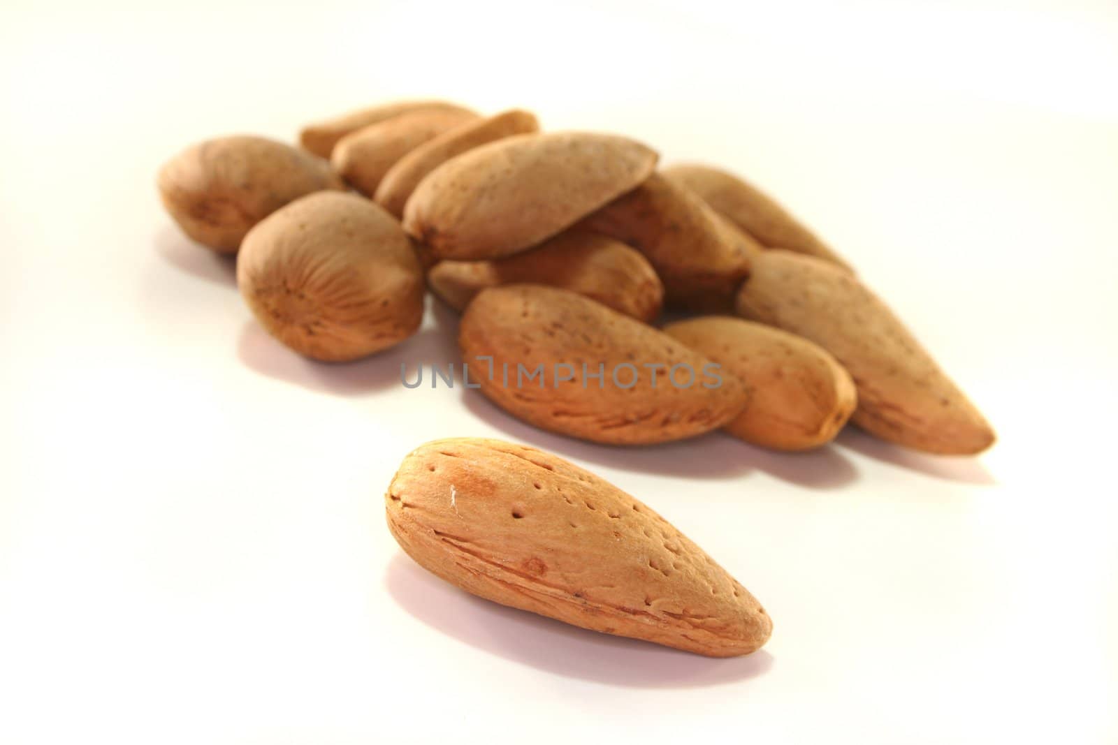 Almonds  in a pile on a white background