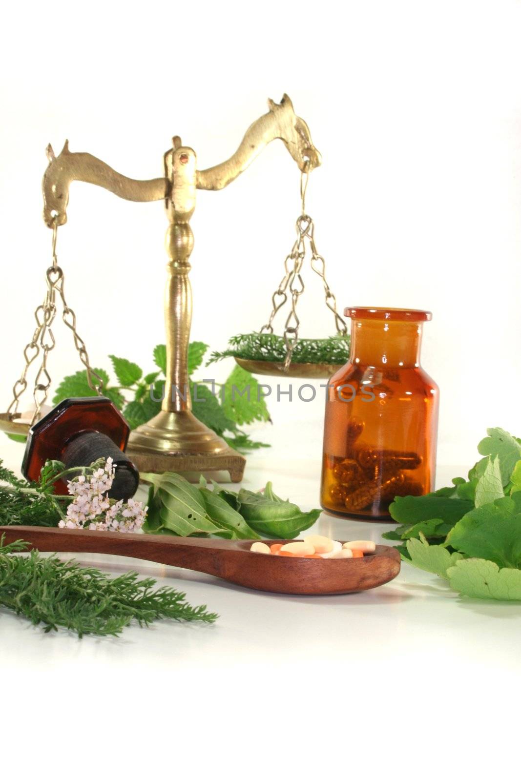 Pharmacists scale with tablets, Apothecary bottle and fresh herbs