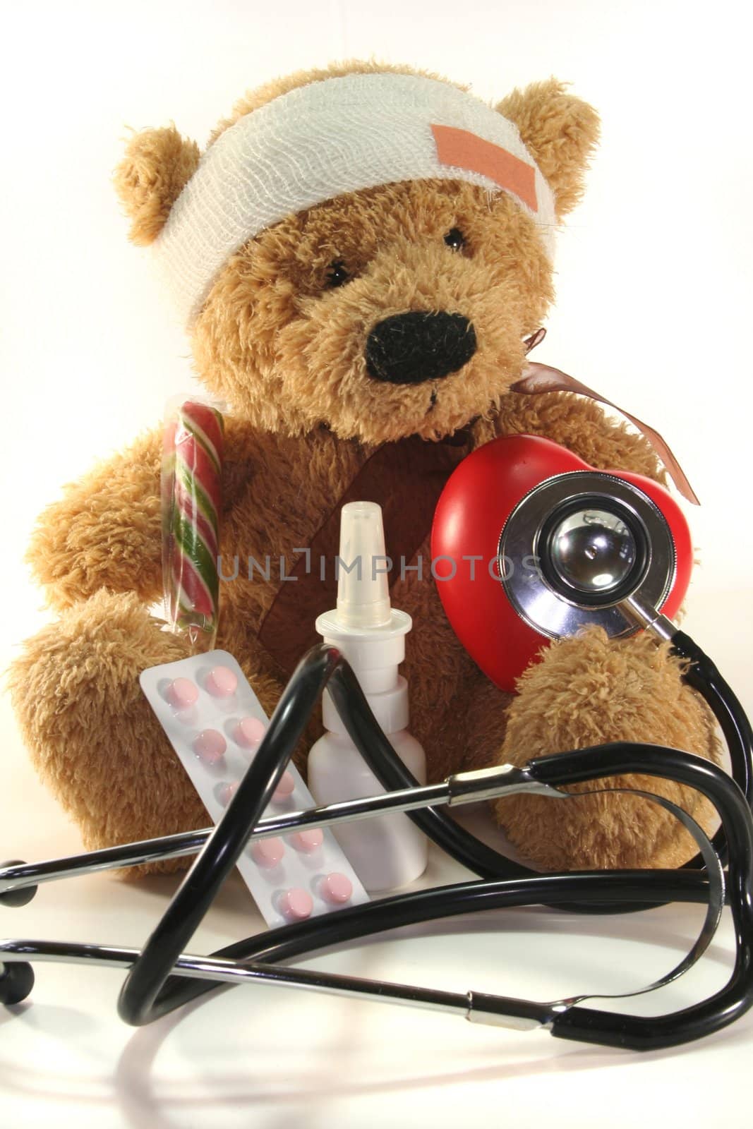 injured Teddy child with doll doctor on a white background