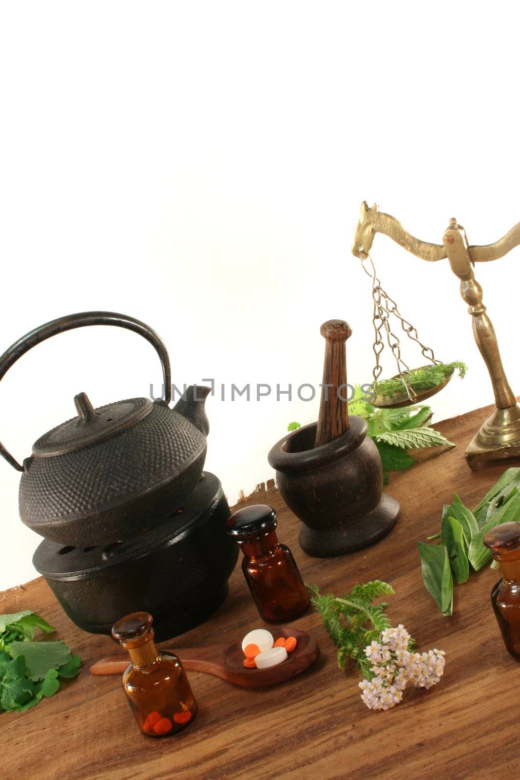 Pharmacists scale with Tea kettle, apothecary bottles and fresh herbs