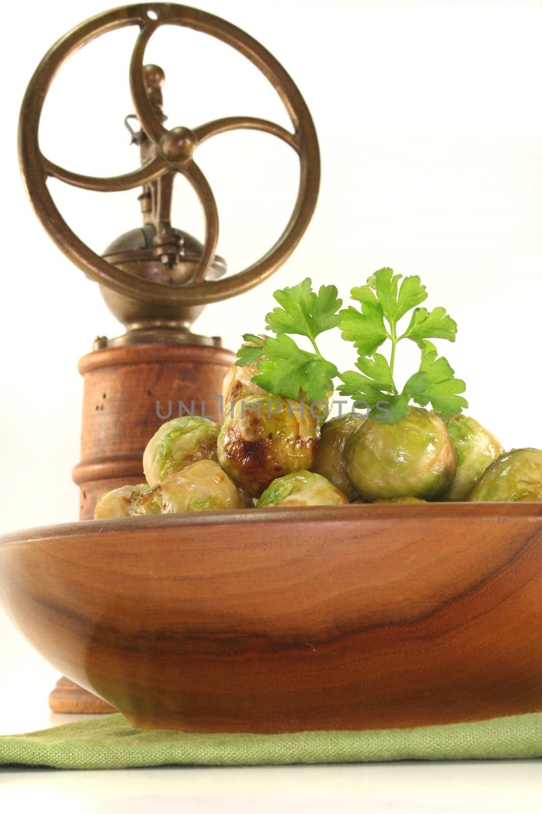roasted brussels sprouts in a wooden bowl on a green napkin