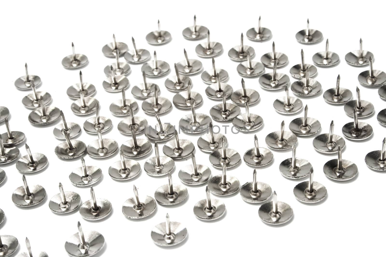 Silver tacks on white background