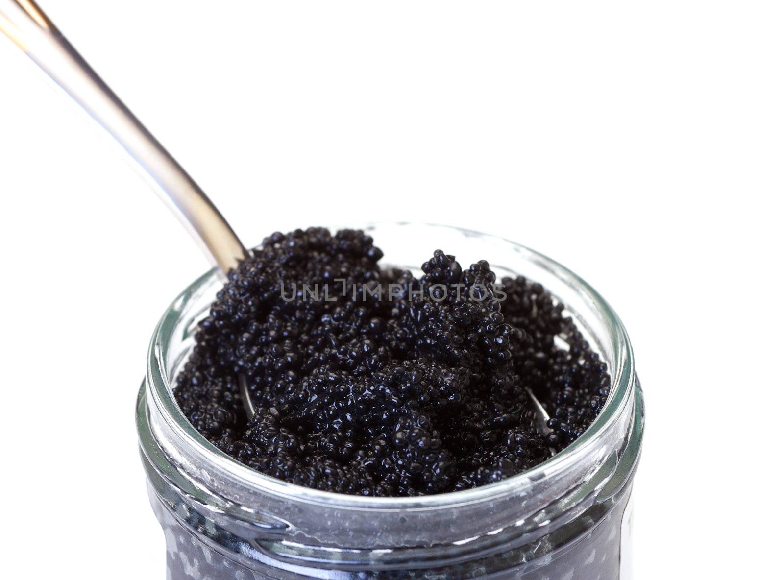 Black caviar on a spoon, white background
