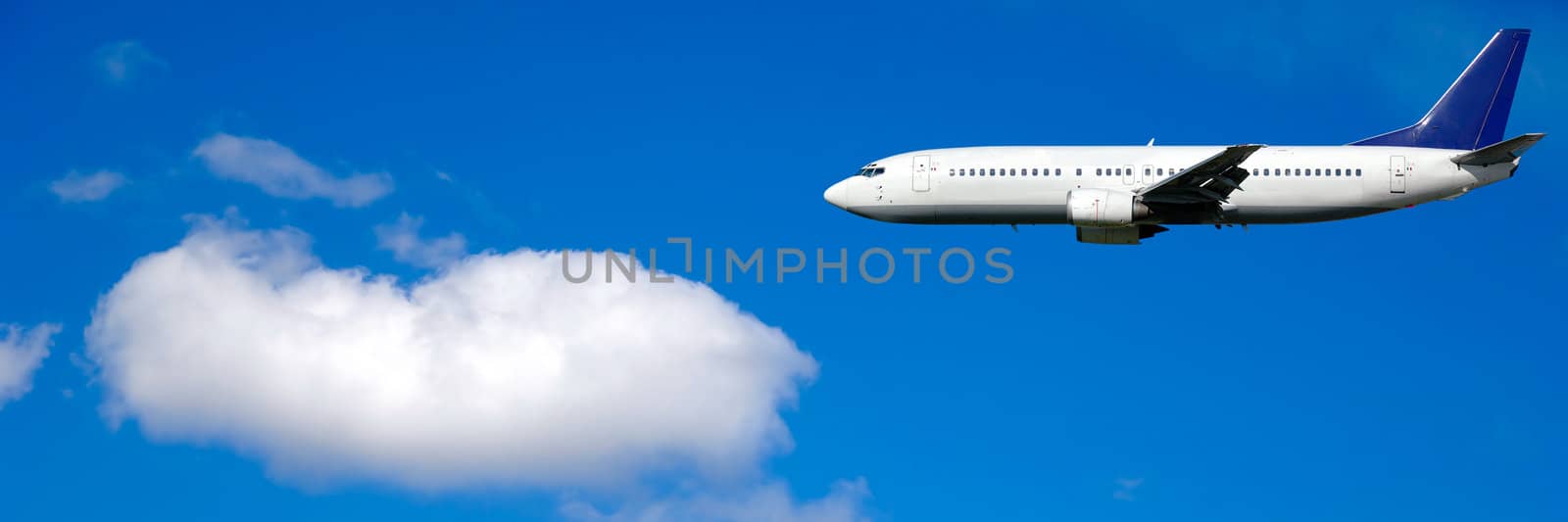 Air travel - Plane and cloud on blue sky by cfoto