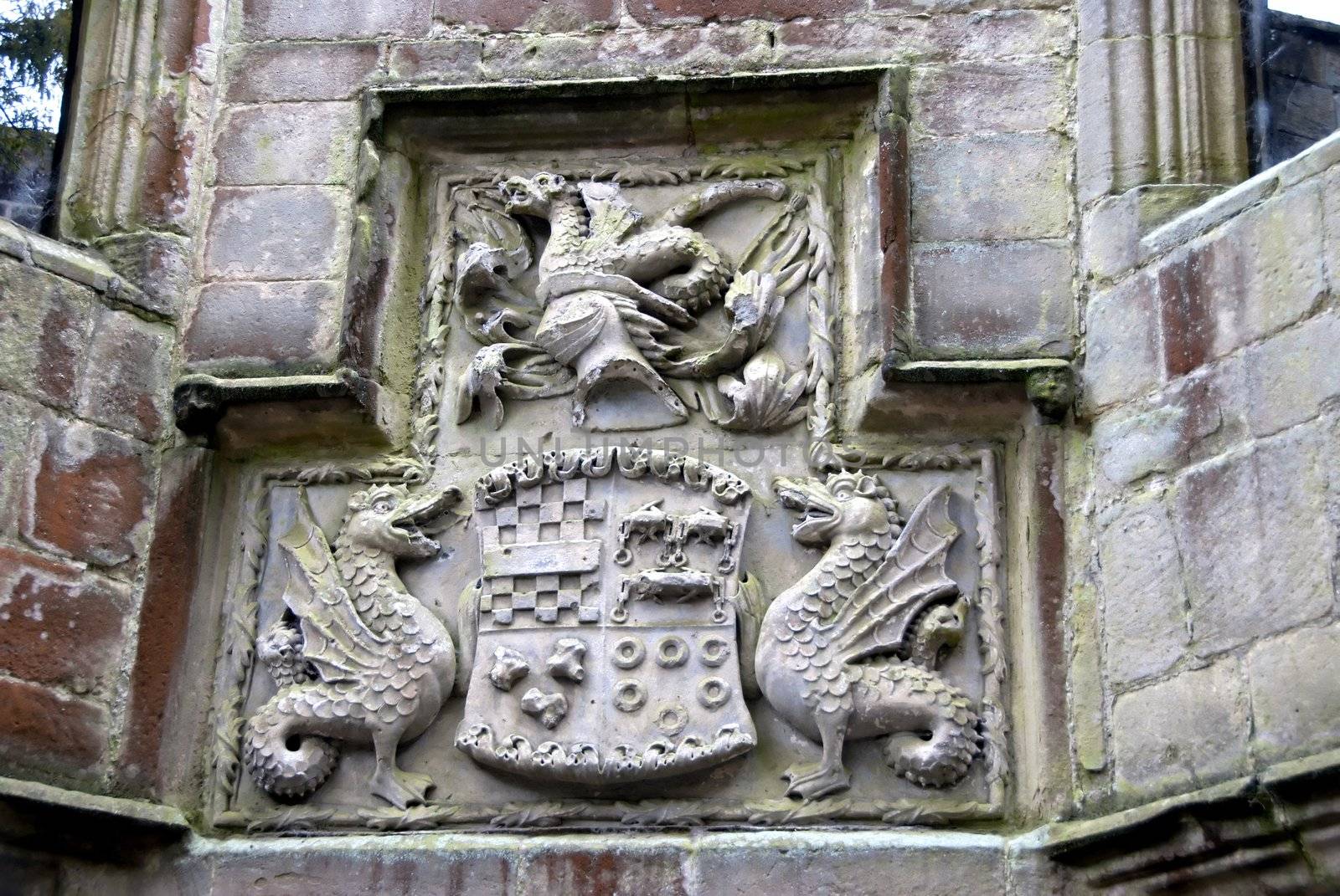 A family coat of arms carved from stone in the courtyard of a medieval castle in Yorkshire