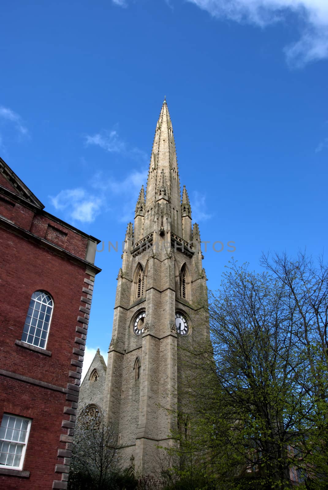 The Spire of a ruined church  in Yorkshire against a blue sky