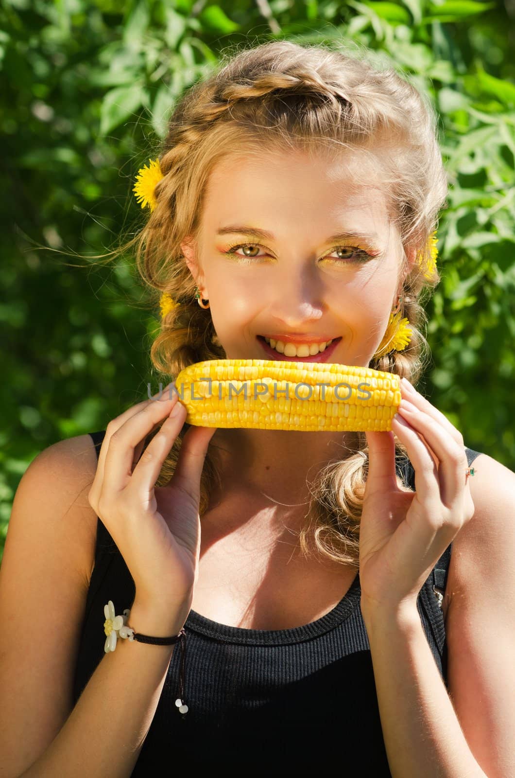 Close-up outdoor portrait of young beauty woman eating corn-cob