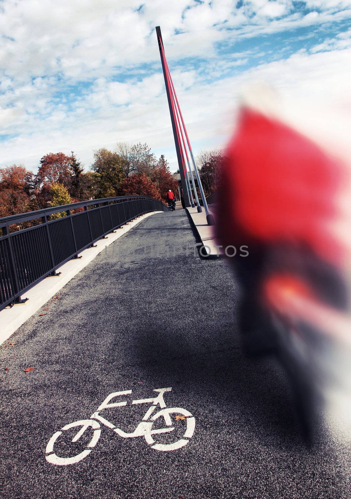 biker roadsign on the grey asphalt of a bridge
