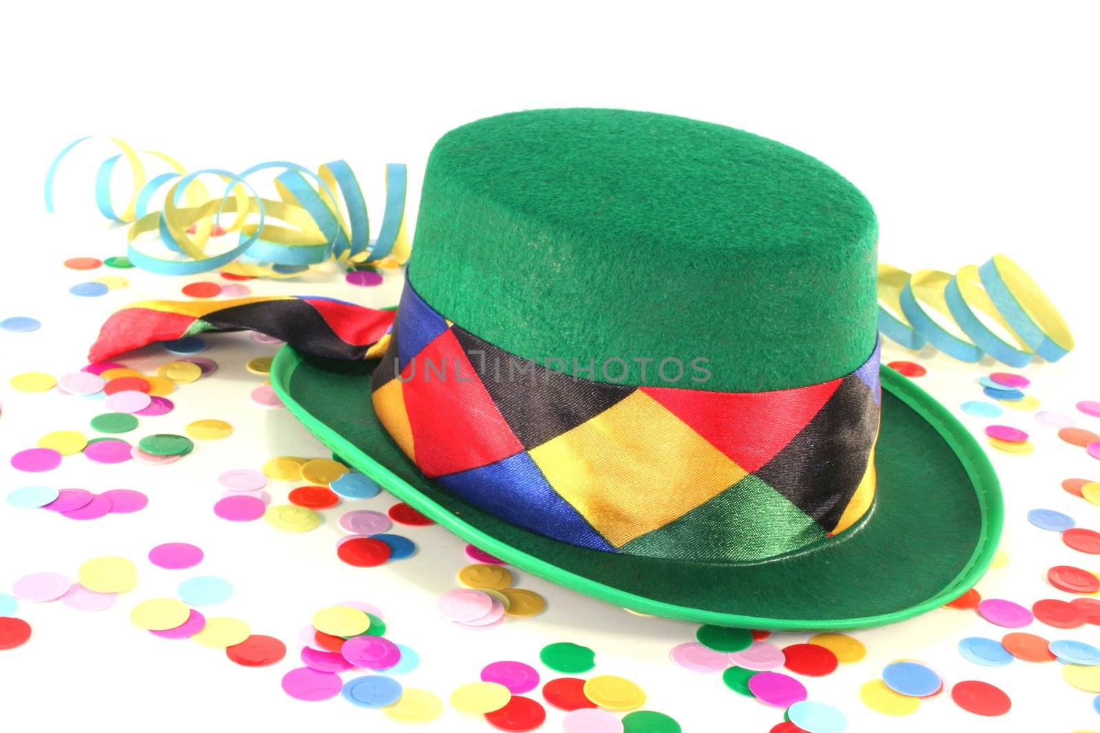 Carnival hat with colorful confetti and streamers on white background