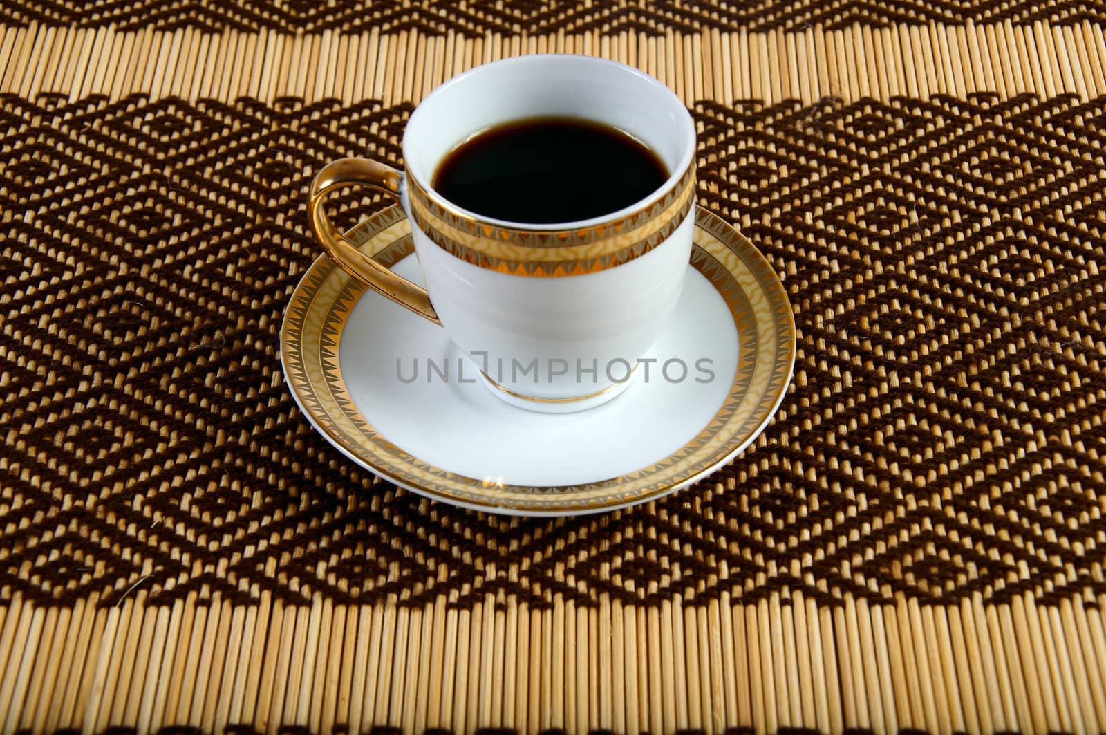 Decorated cup of coffee on a napkin from the plant material