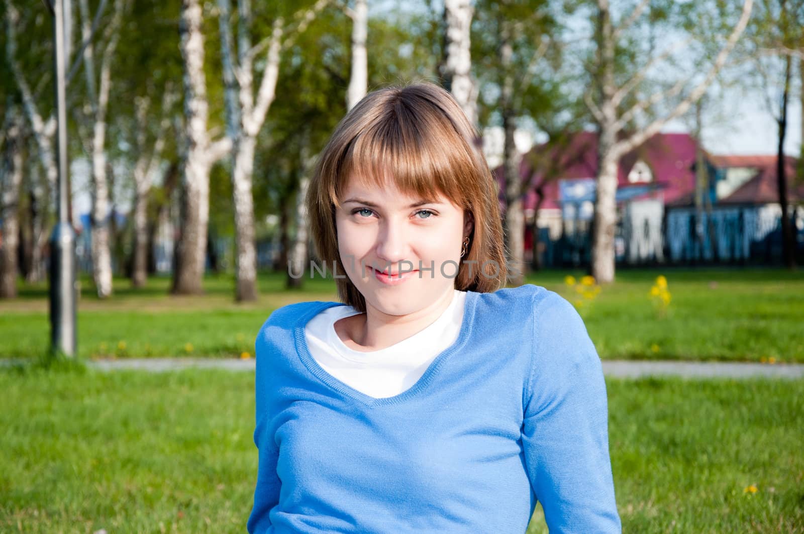 smiling young girl sitting in the park
