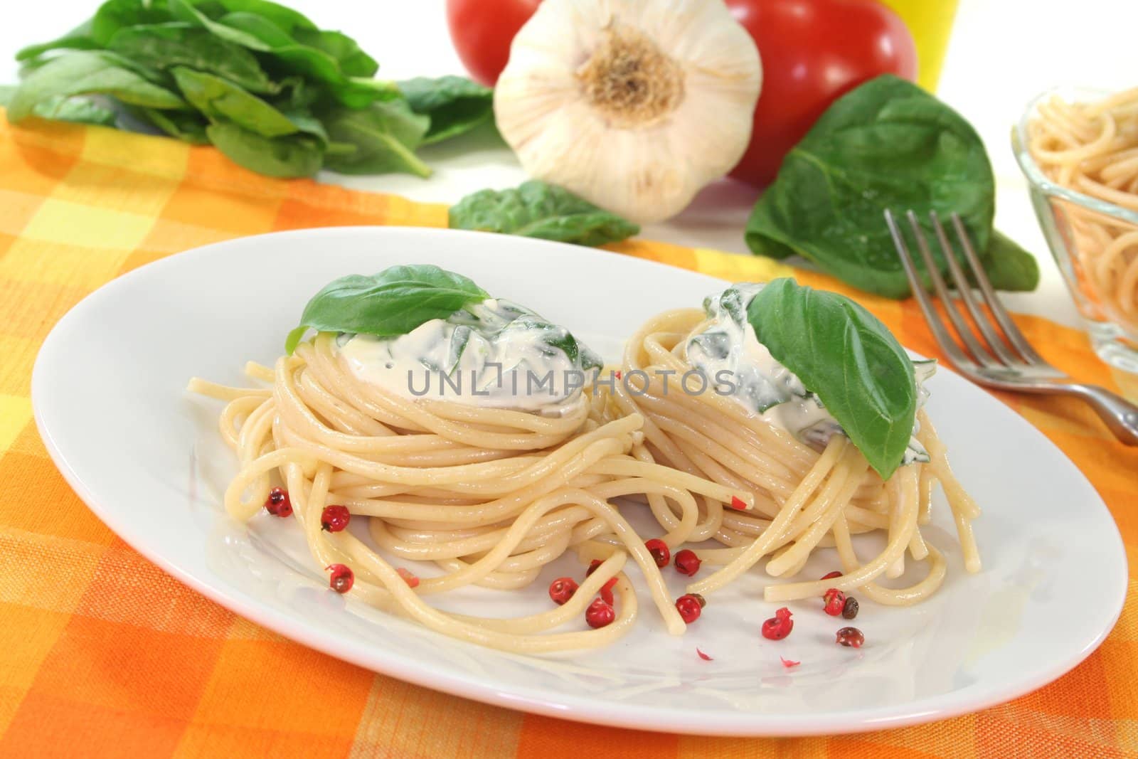 Noodle nests with cheese-spinach sauce and fresh basil