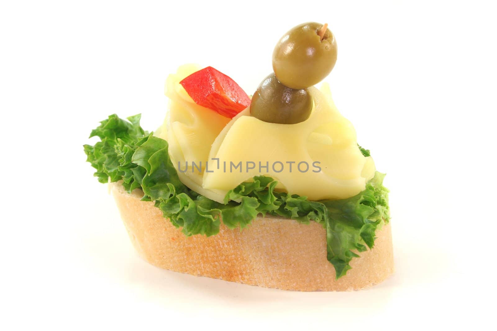 Canap� with lettuce, cheese, peppers and olives on a white background