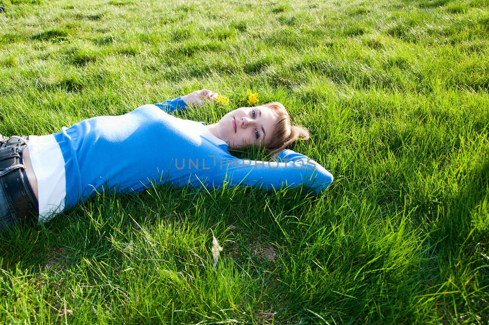 beautiful girl lying on the grass by adam121