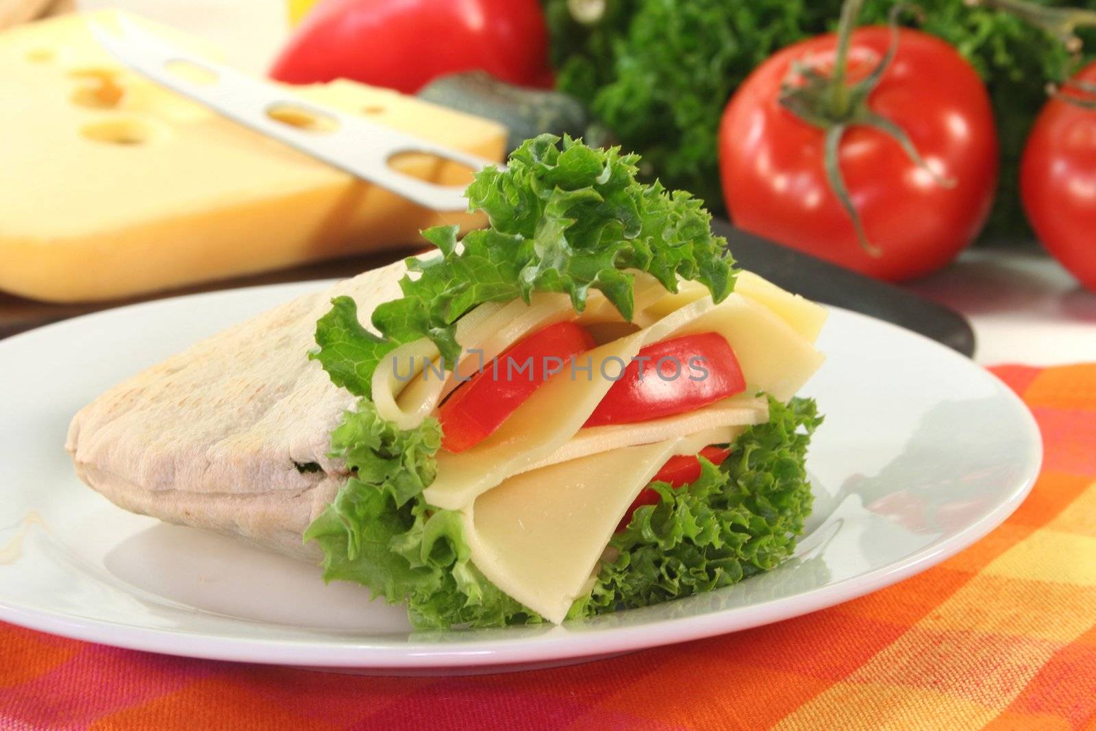 Pita with lettuce, cheese, and peppers on a white background