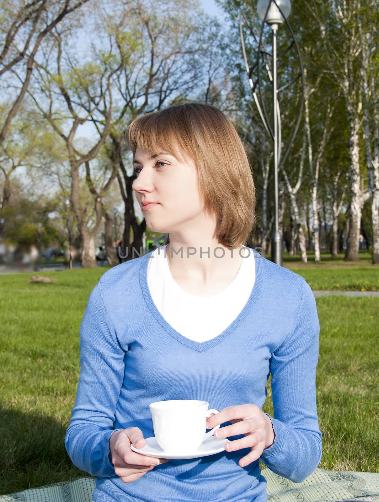 girl drinking tea in the park