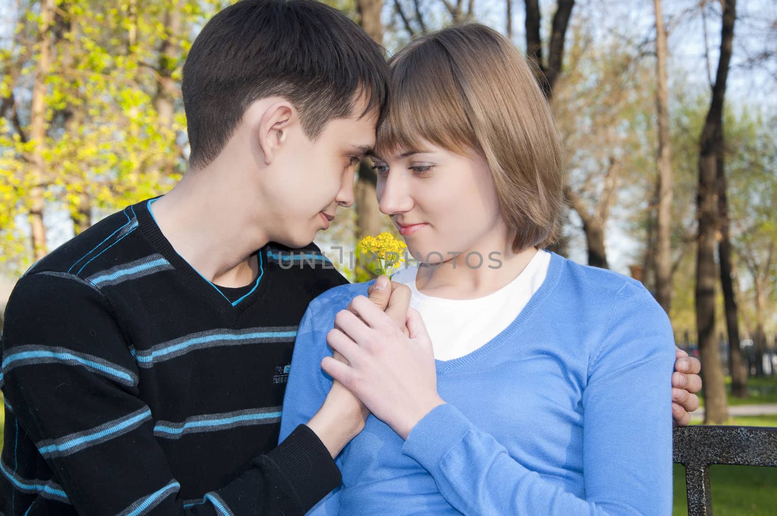 guy hugs young girl in the park