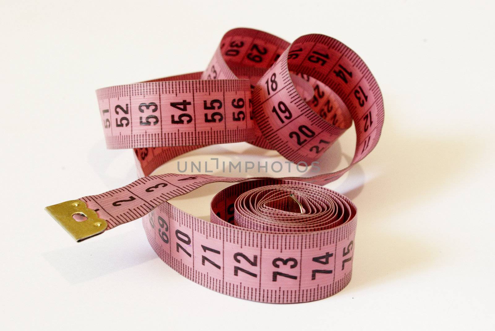 Pink meter tailor a spirally wound on a white background