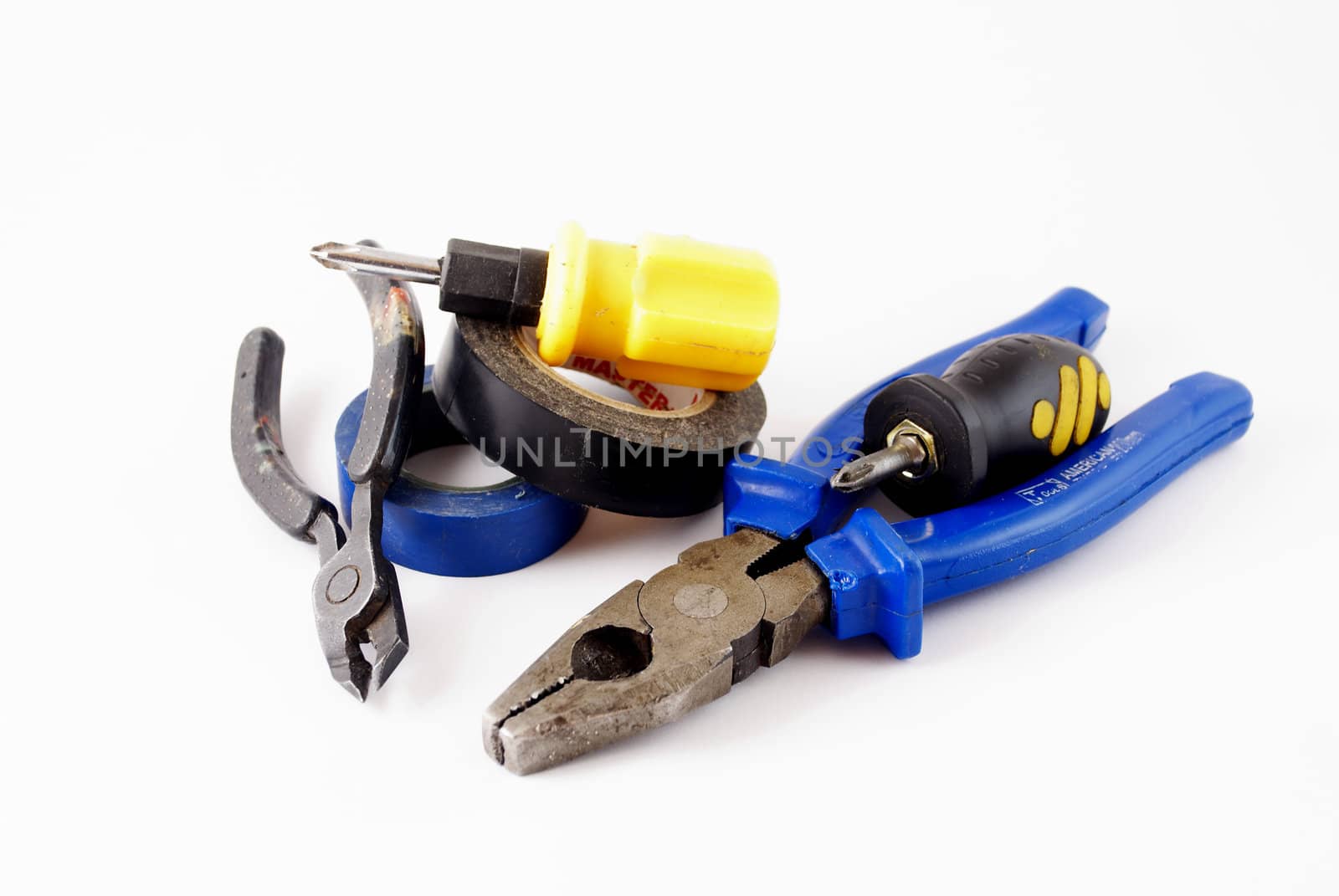 pliers, wire cutters, screwdrivers, electrical tape on white background