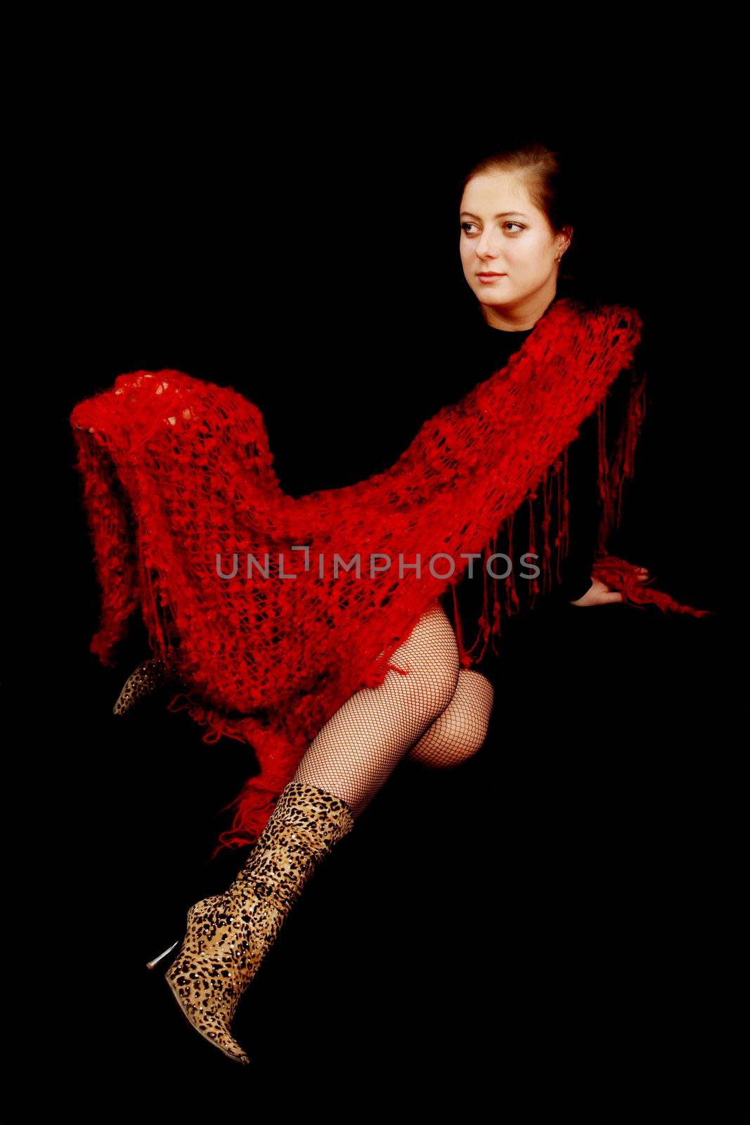 Young beautiful girl with a yarn on the dark background

