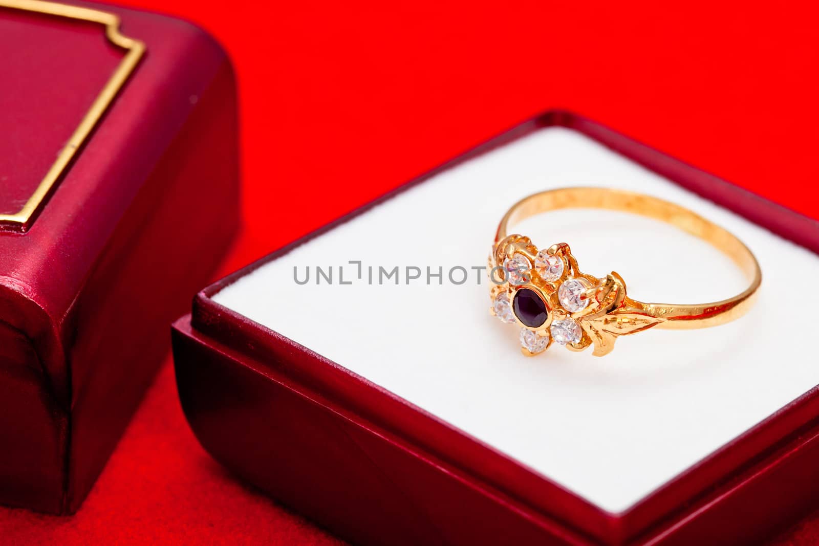 Fantastic gold ring adorned with one blue  and several white zirconia