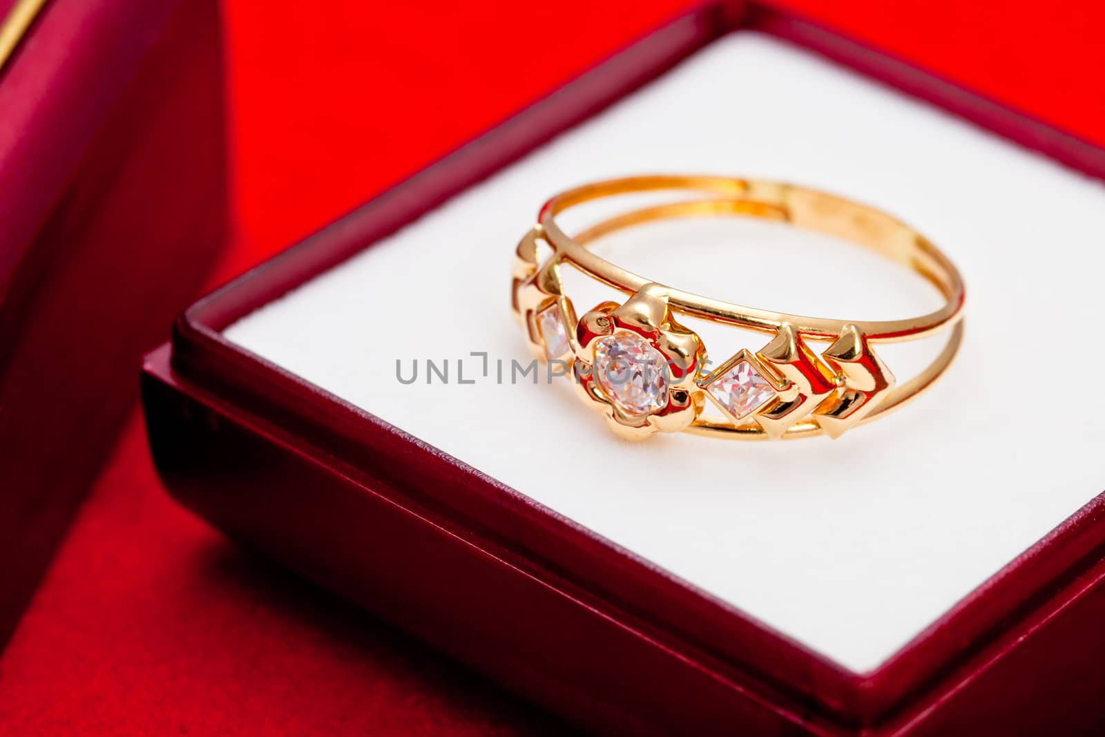 Fantastic gold ring adorned with one blue  and several white zirconia