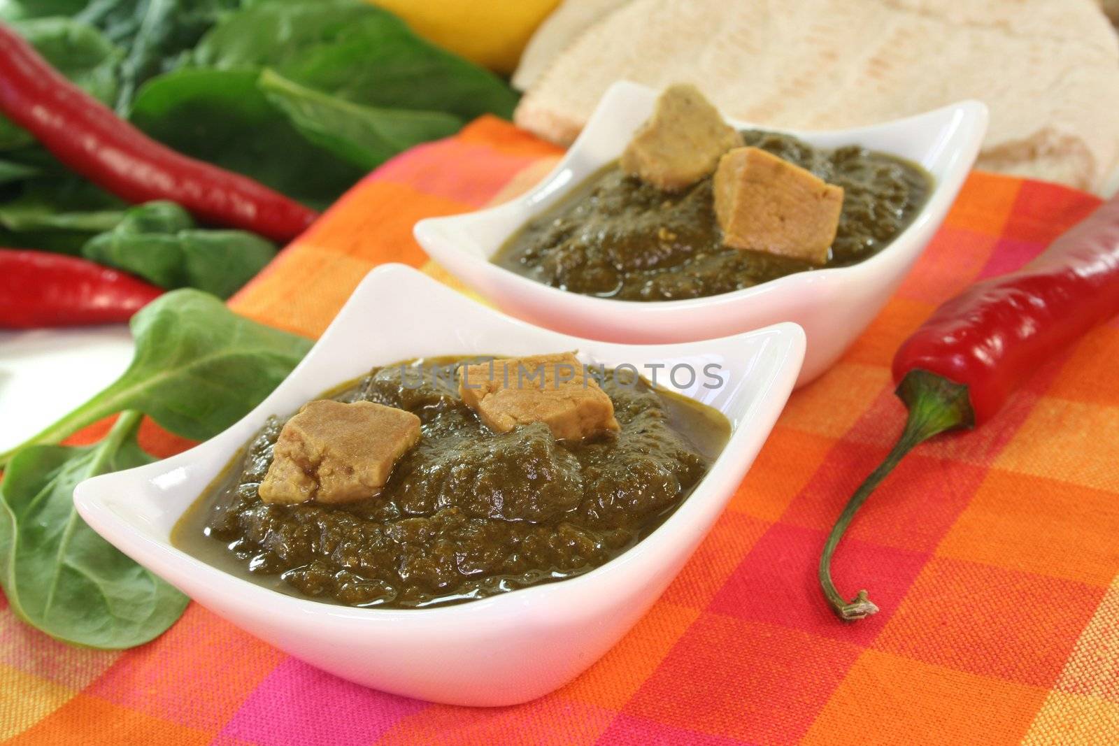 Indian Palak Paneer with mixed rice, ginger and Asian spices on white background