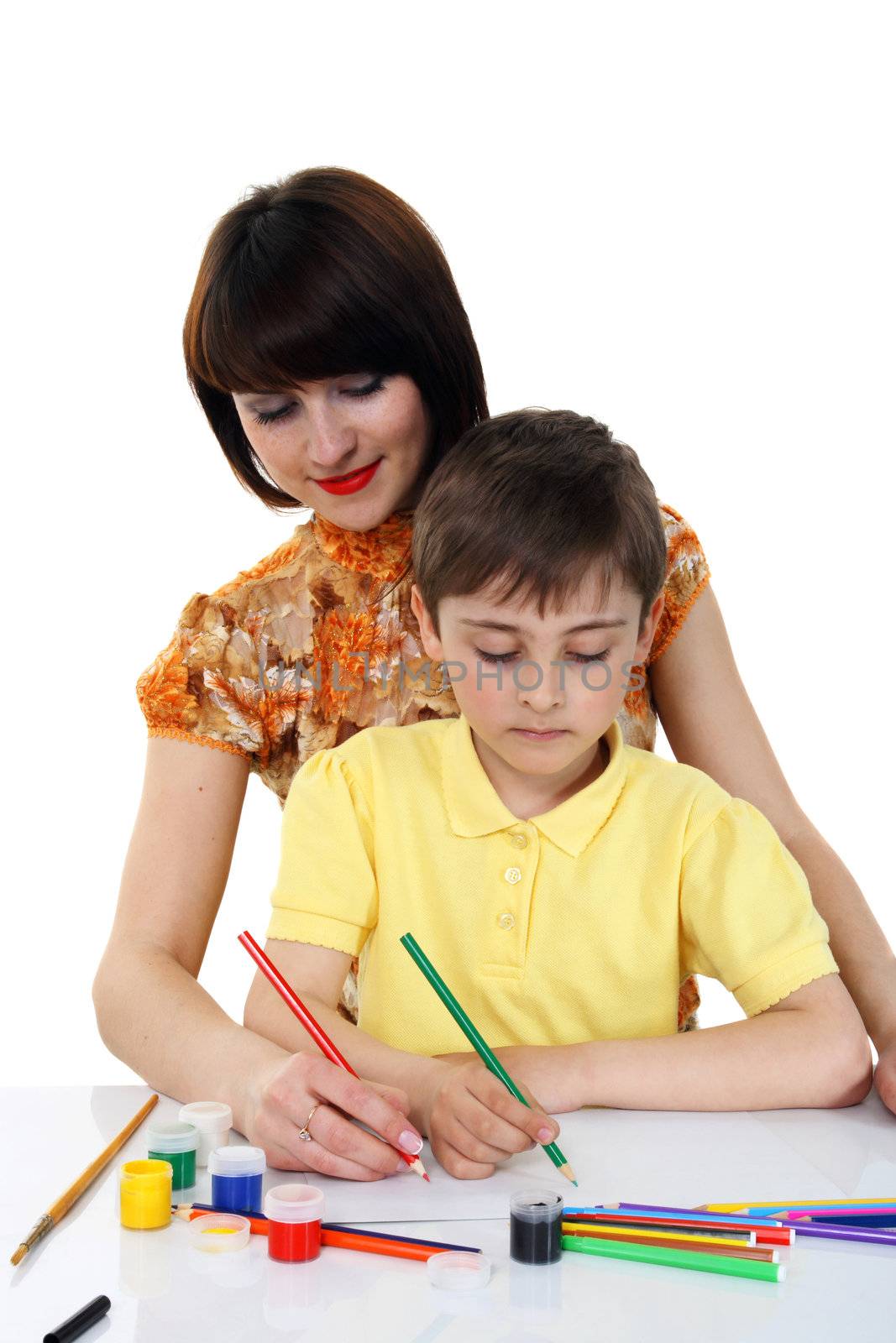 small boy and a young girl with colored pencils on the white background
