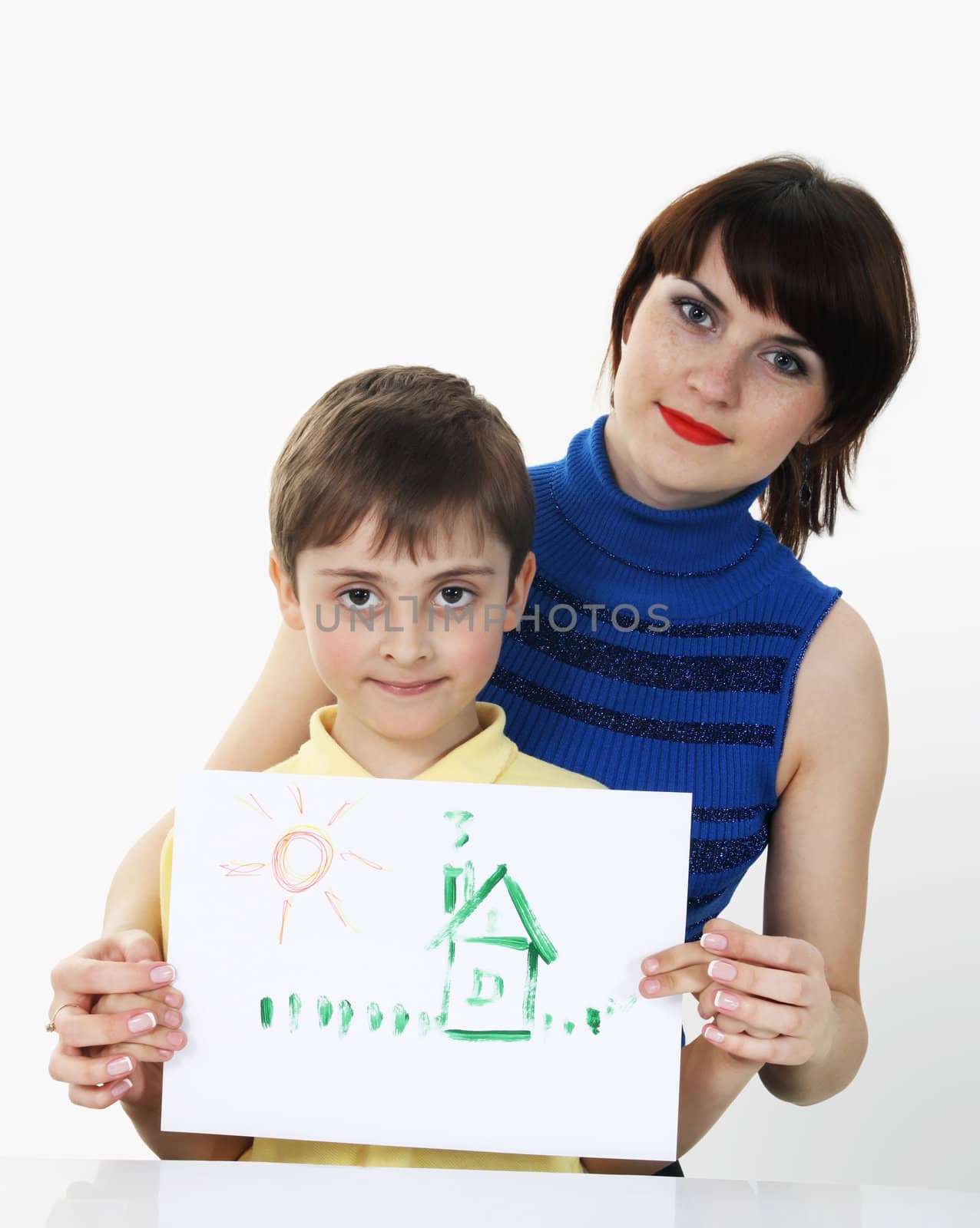 Young beautiful girl with a boy, holding a picture in the hands of the gray background
