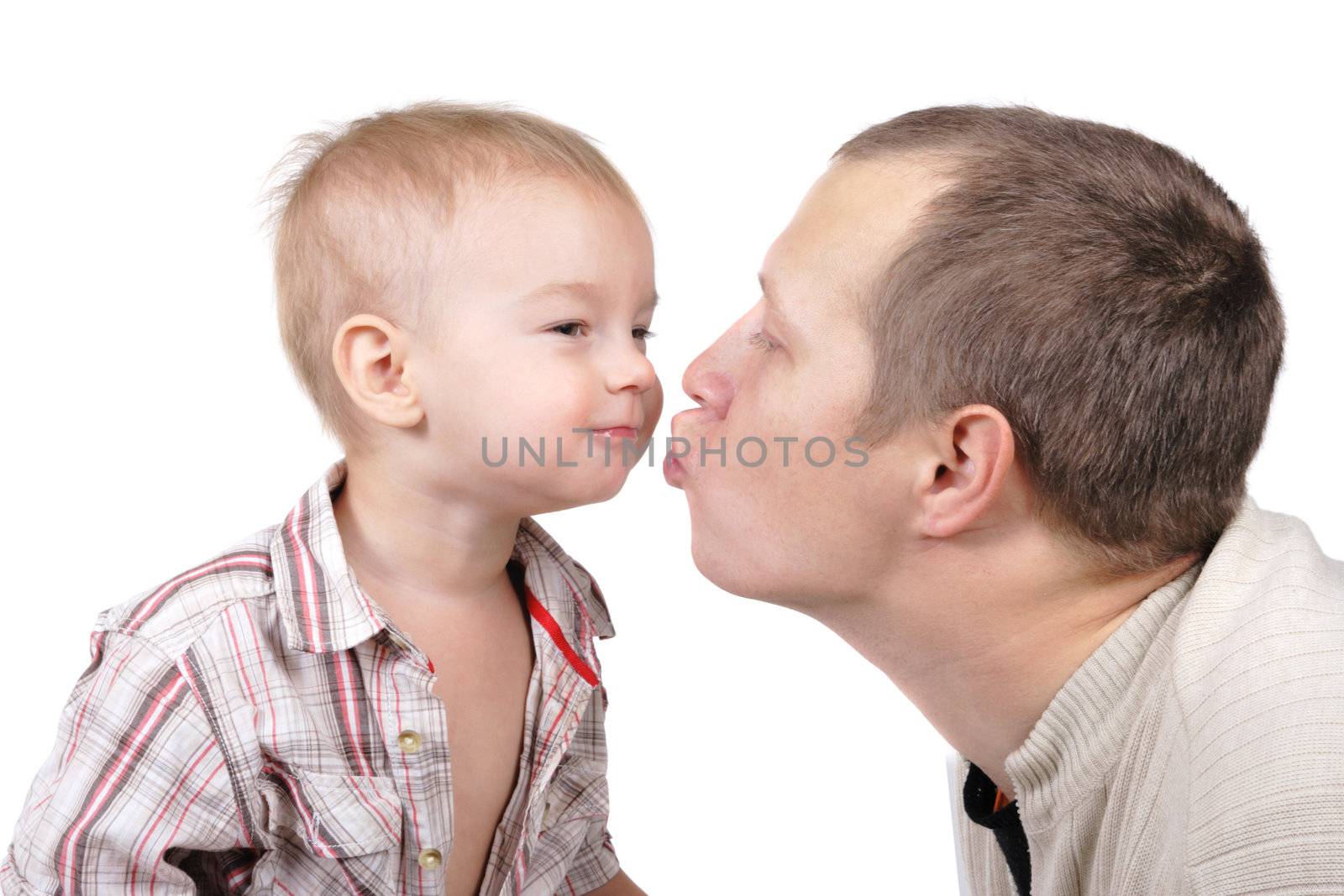 Daddy kisses his little son on the white background
