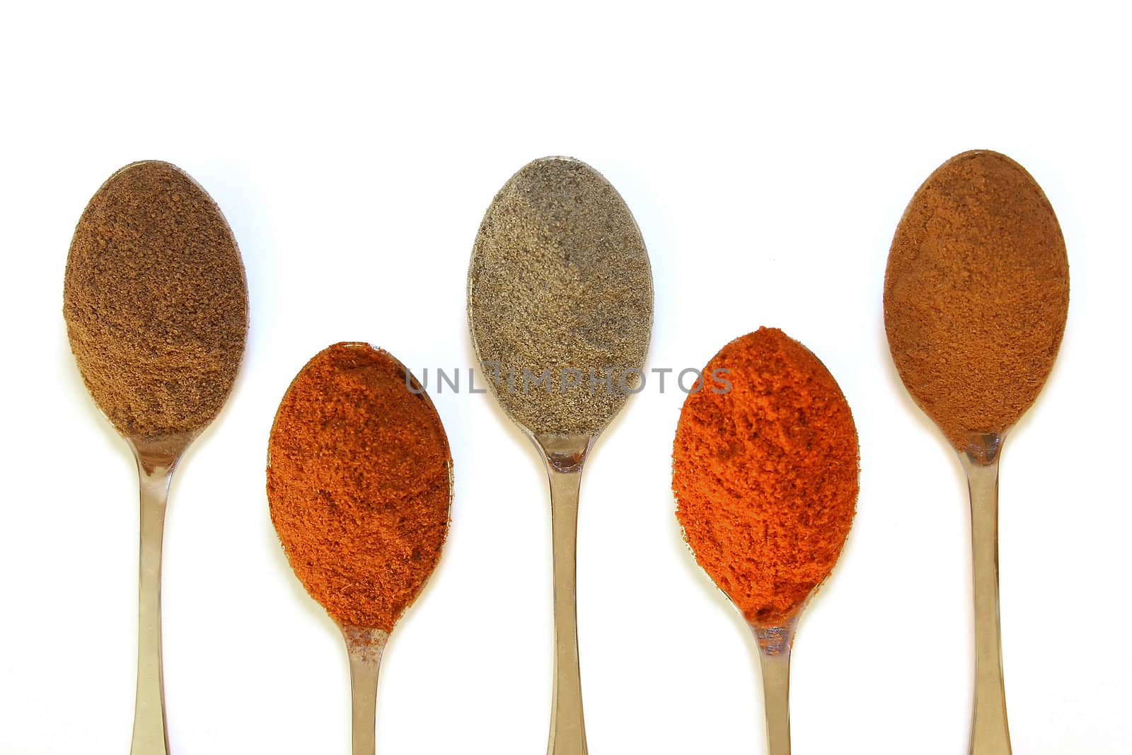 five spoons with various spices