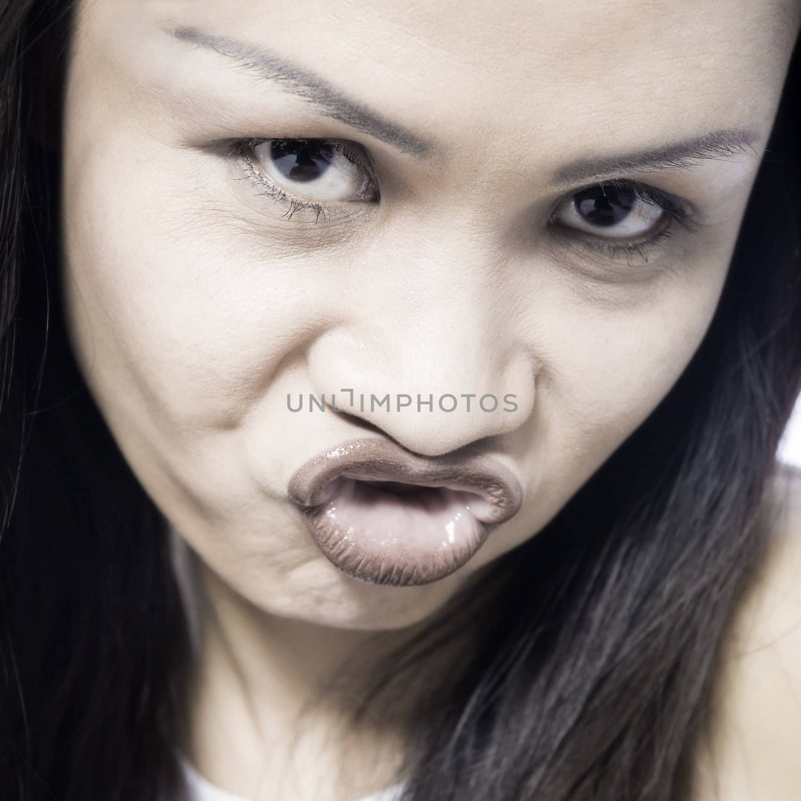 Studio portrait of a asian girl  looking foolish