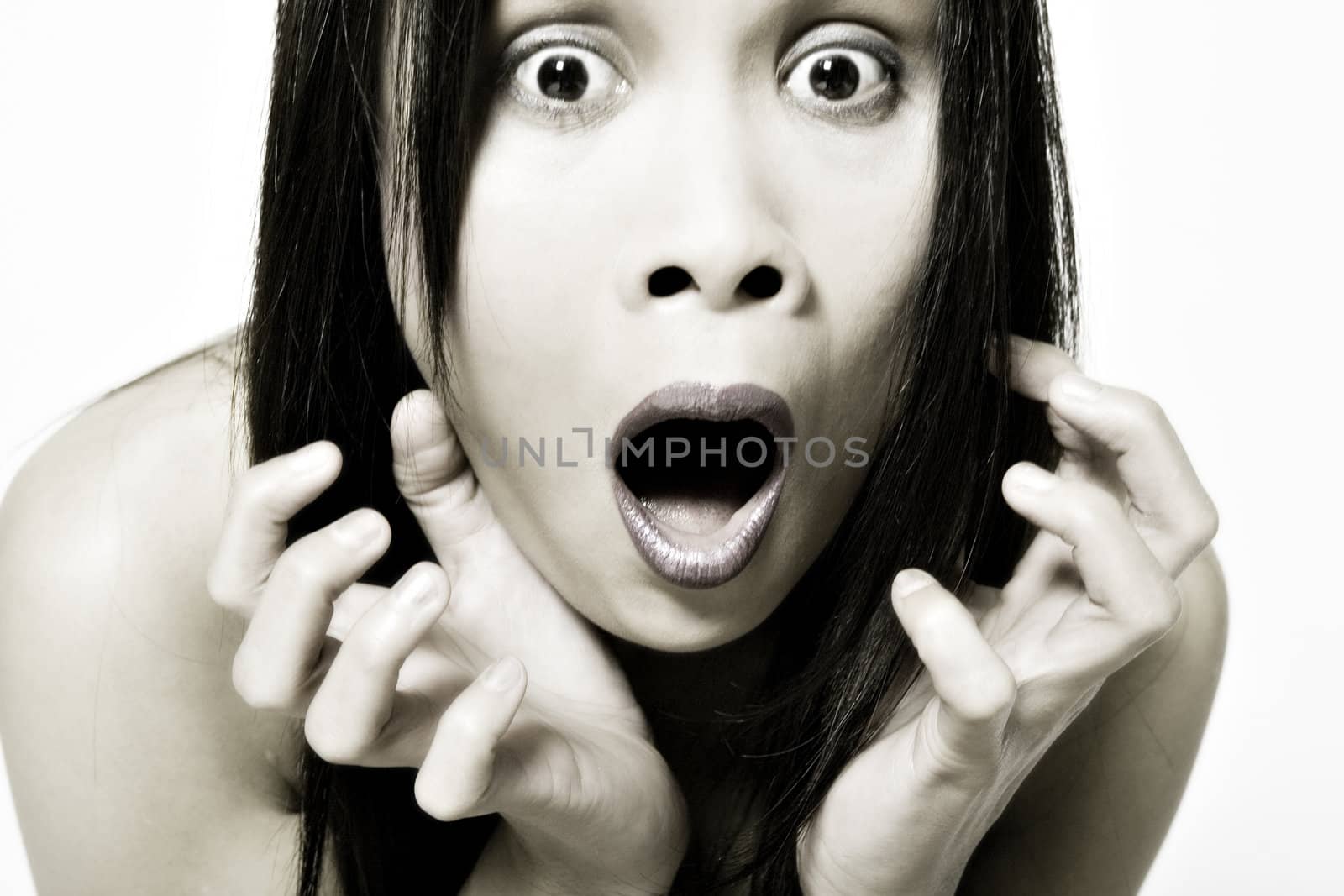 Studio portrait of a asian girl looking scared