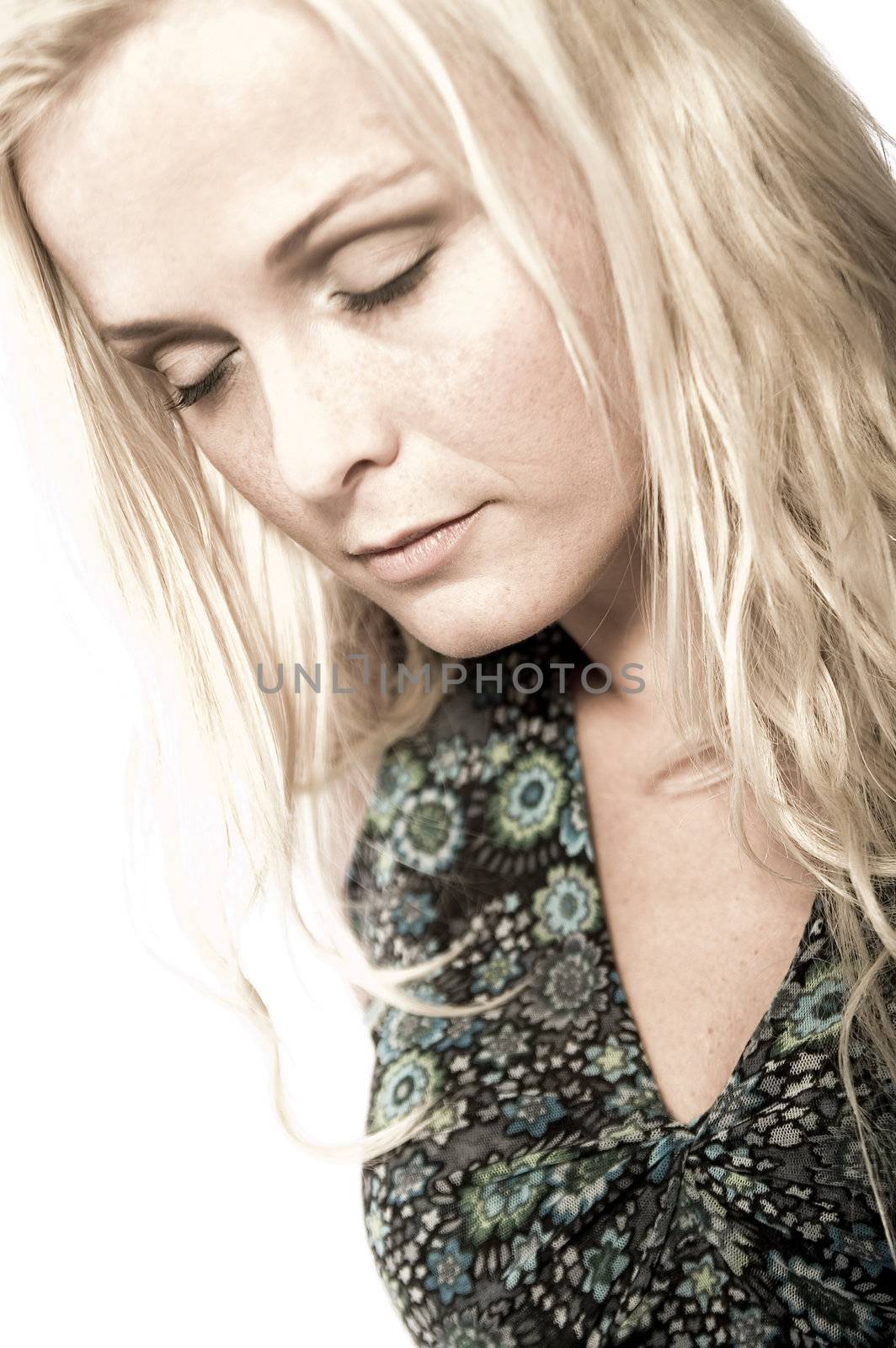 Portrait of a beautiful blond in the studio looking dreamy