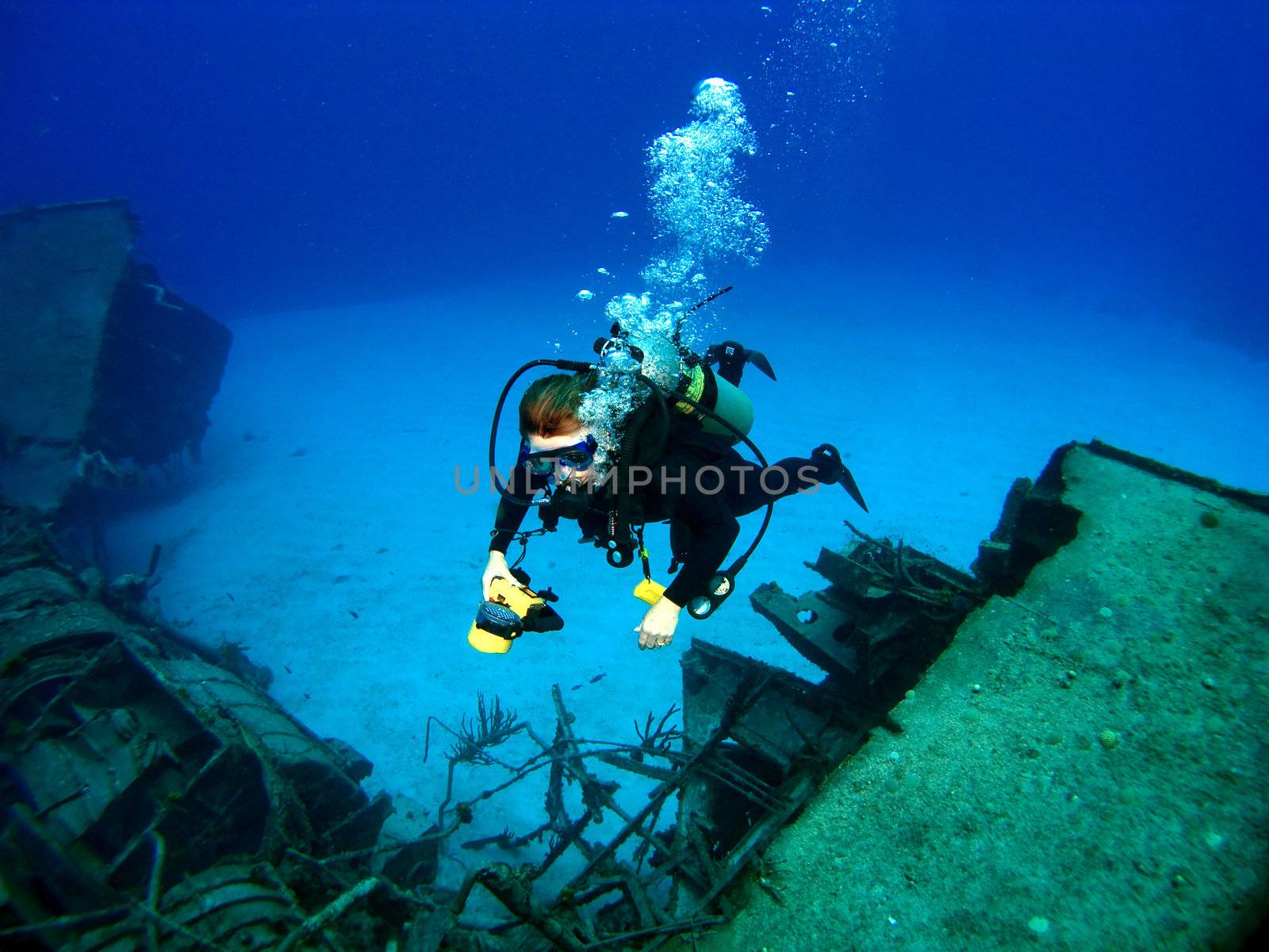 Diver photographing a Sunken Shipwreck in Cayman Brac