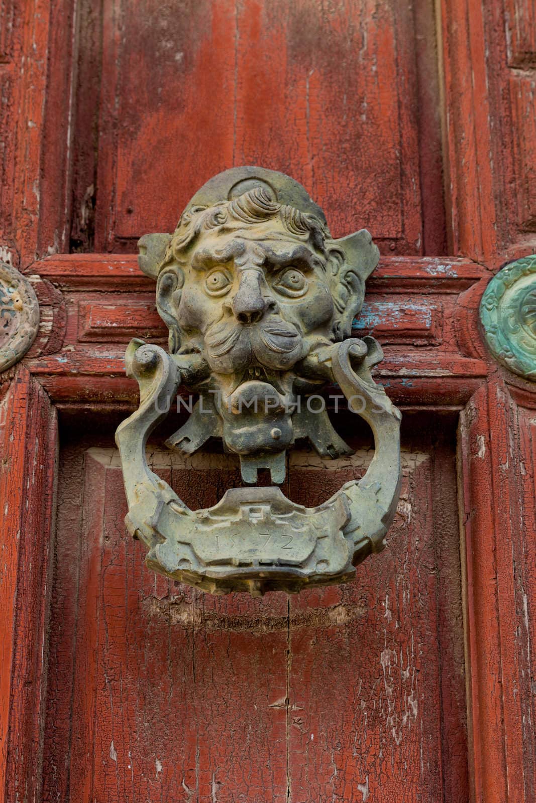 Detail of an ornate door knocker on the door of a building
