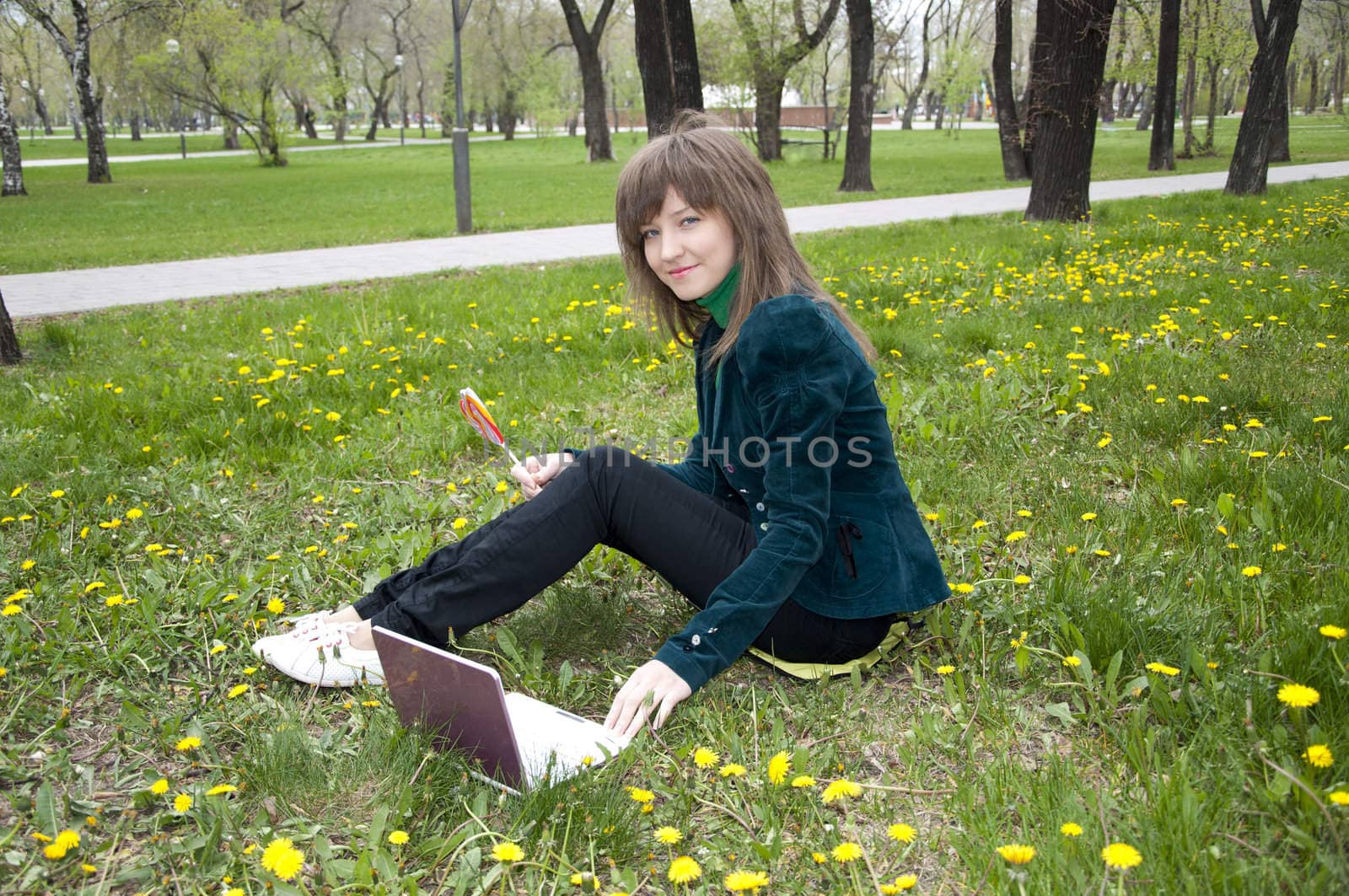 young girl sitting on the grass