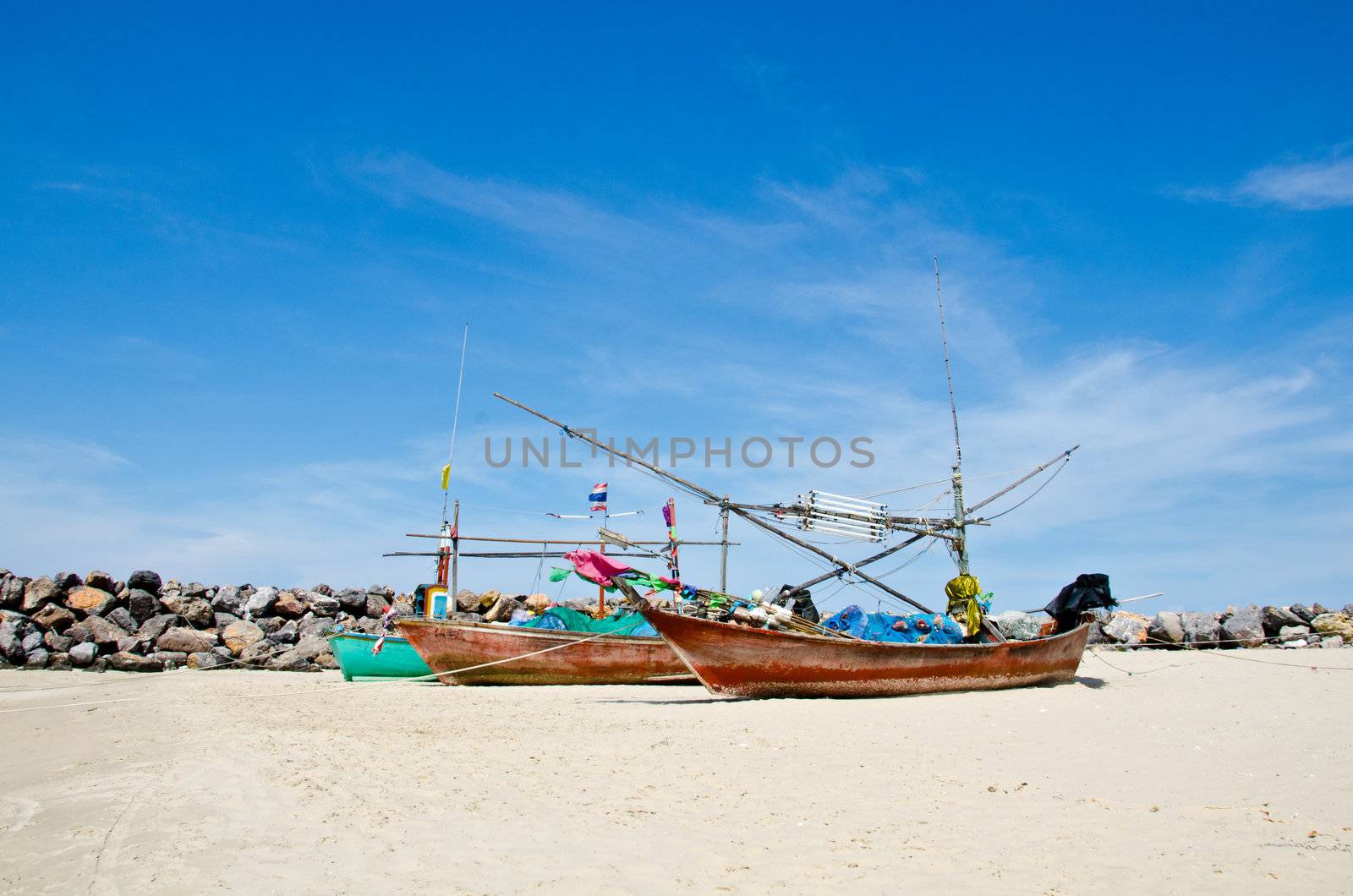 Coastal fishing boats waiting at the water to catch fish. Hua Hin, Thailand.
